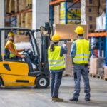 Male and female worker working in warehouse.